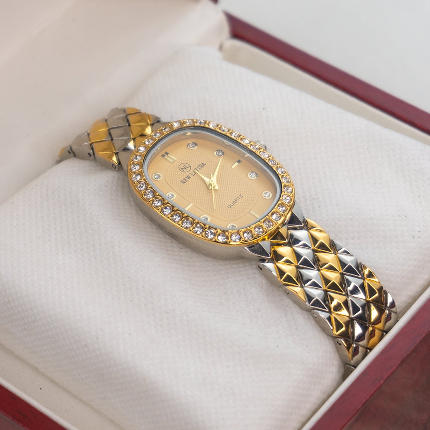 New Latina women's luxury watch with gold oval dial, crystal-studded bezel, and two-tone diamond-pattern bracelet displayed in a premium gift box – part of Explorer’s Dial women’s collection.