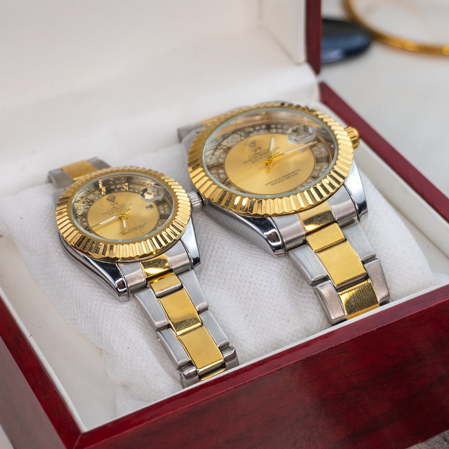 Elegant V9 couple watches featuring matching gold and silver two-tone stainless steel bands with crystal-studded dials – perfect for his and her luxury collection at Explorer’s Dial.